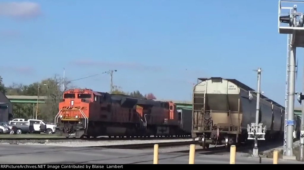 BNSF coal train passes the end of a CN grain train